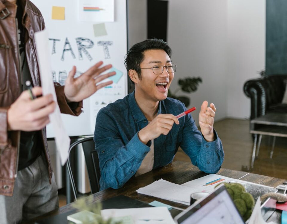 Engaged team members in a lively office meeting discussing startup ideas and innovation.