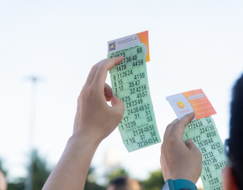 Close-up of hands holding transportation tickets, showcasing numbers and fare details.