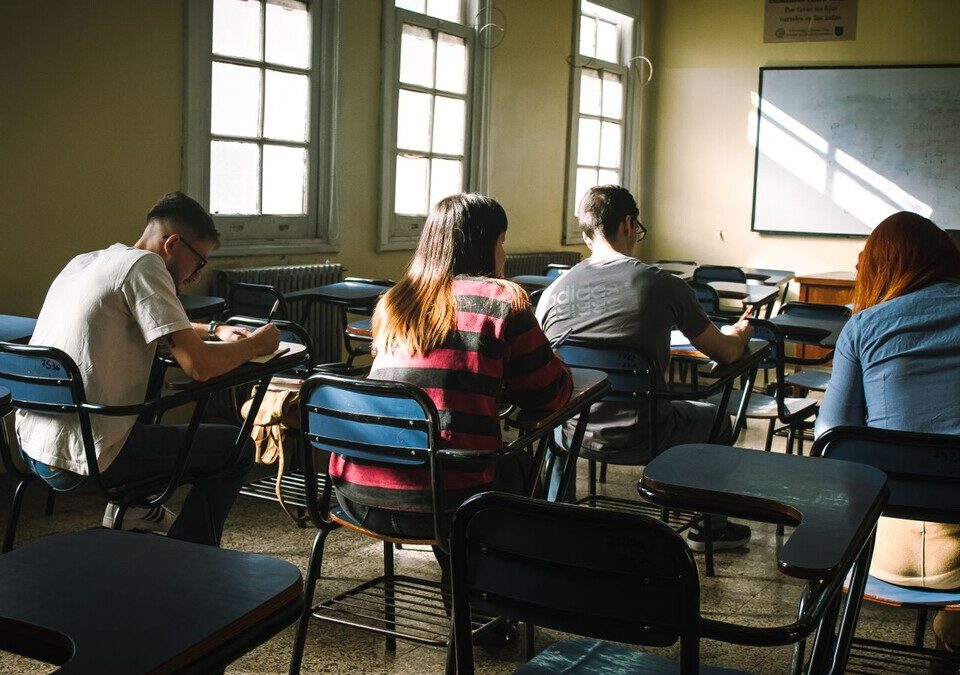 Estudantes concentrados em suas carteiras em sala de aula